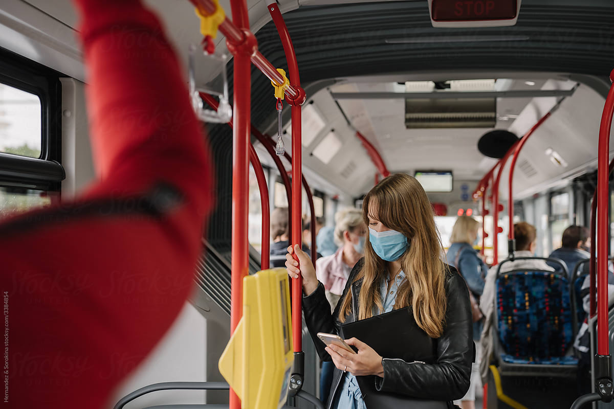 Woman inside Public Transport Wearing Surgical Mask