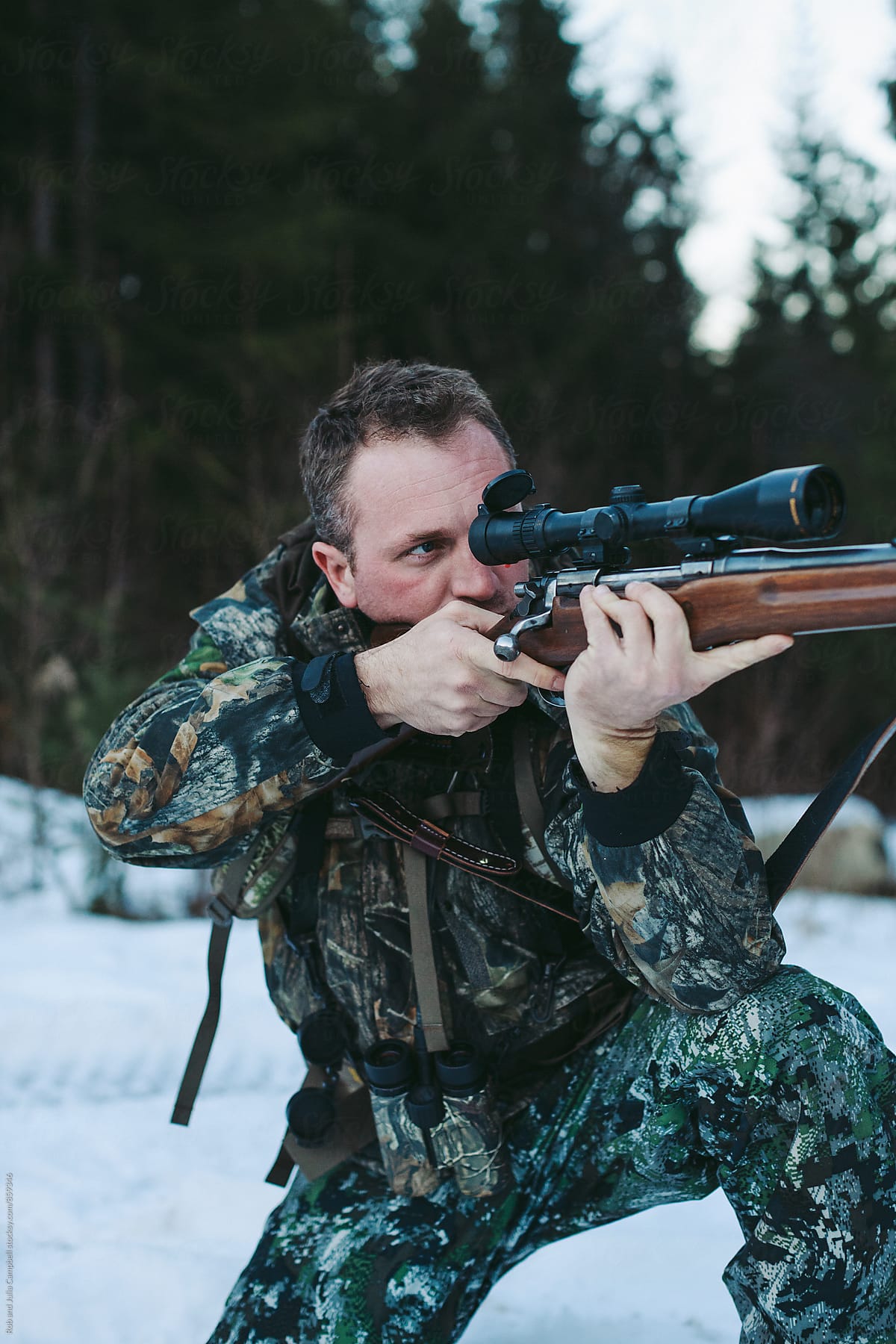 Hunter taking aim with rifle