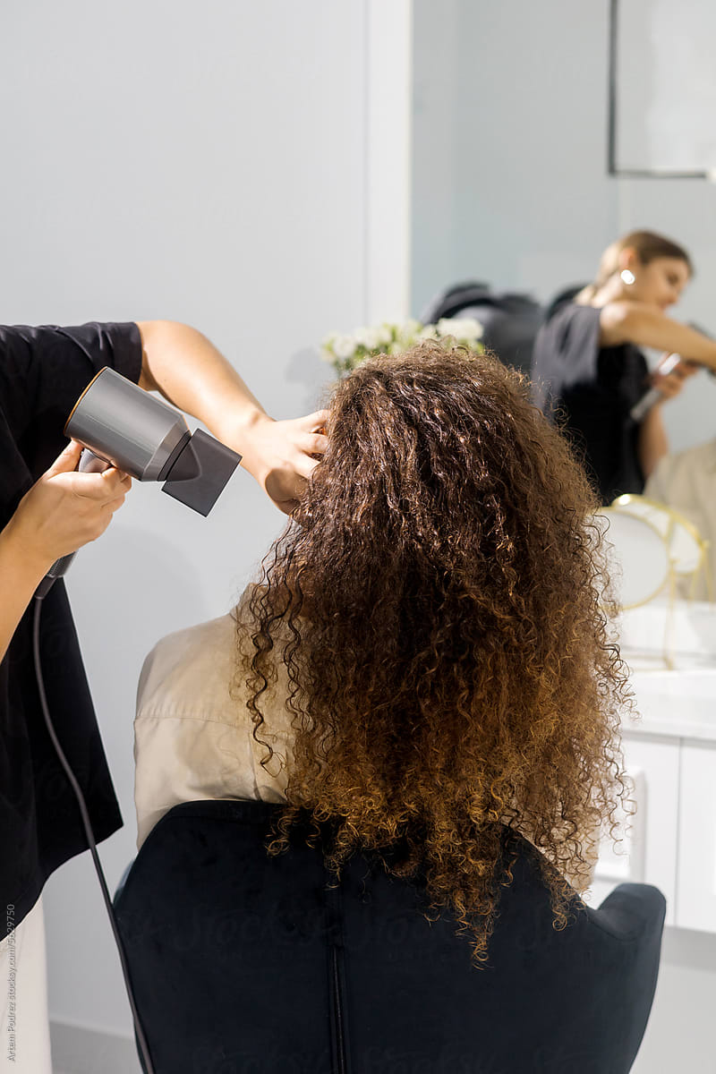 Woman Hair Stylist Perfecting a Curly Look
