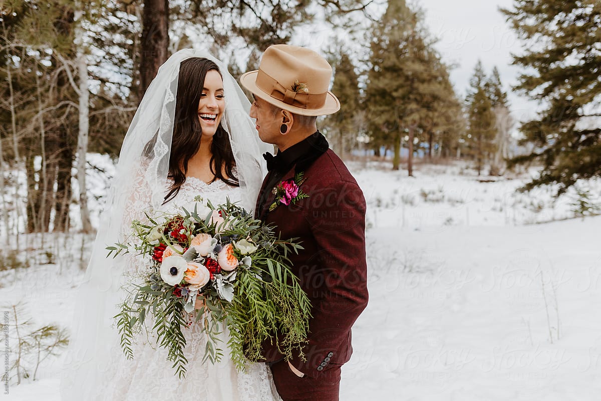 Wedding Couple Laughing in the Snow