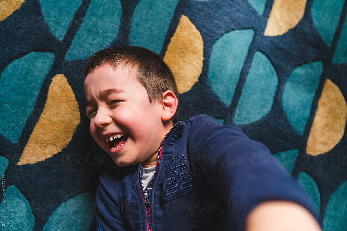 Laughing Kid on a Carpet