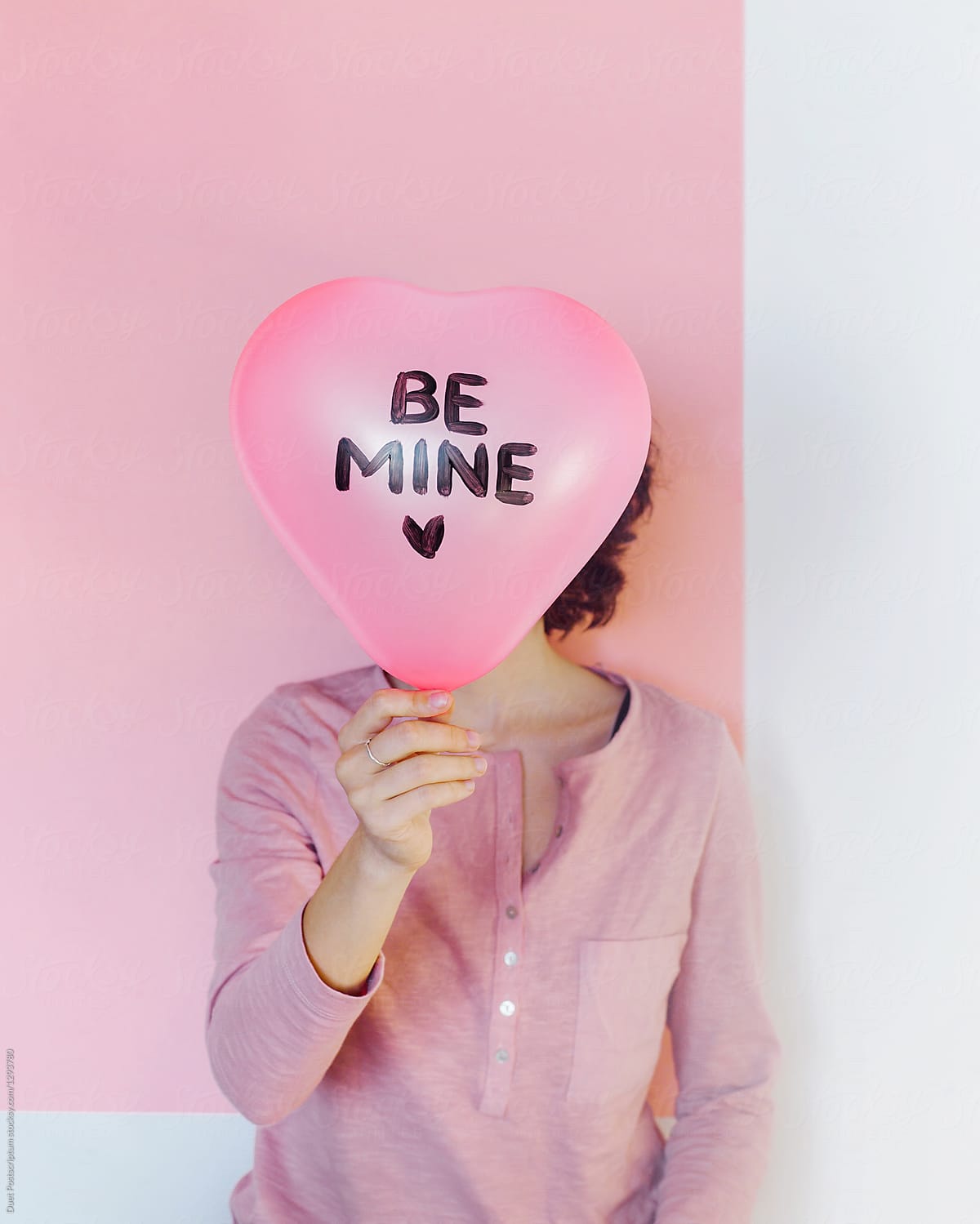 Woman posing with Be Mine balloon