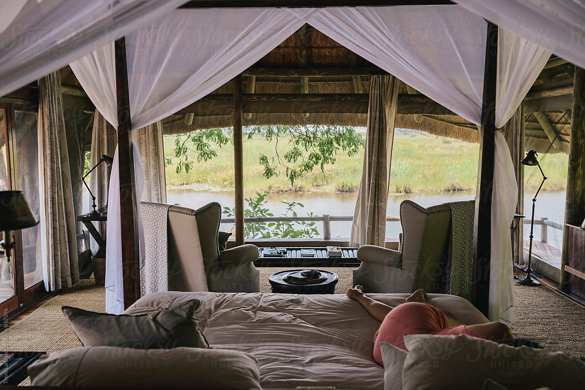 Woman having nap in african safari house with view