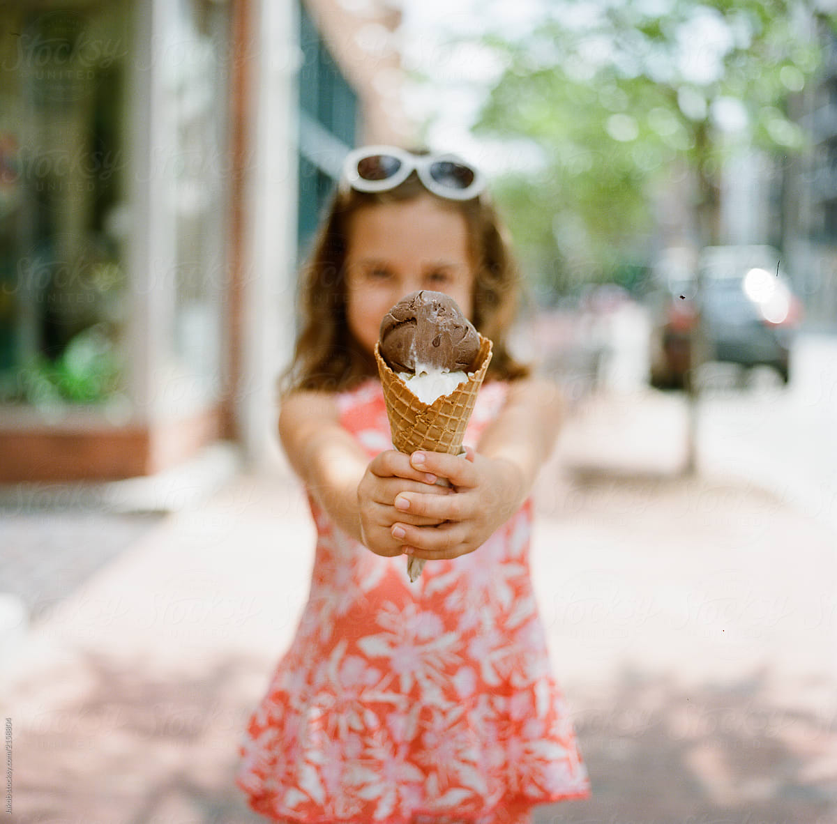 Cute young girl excited to eat a big ice cream