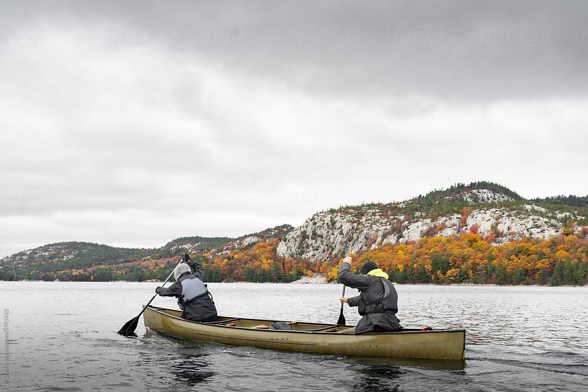 Paddling Kevlar Canoe with Wilderness Autumn Forest