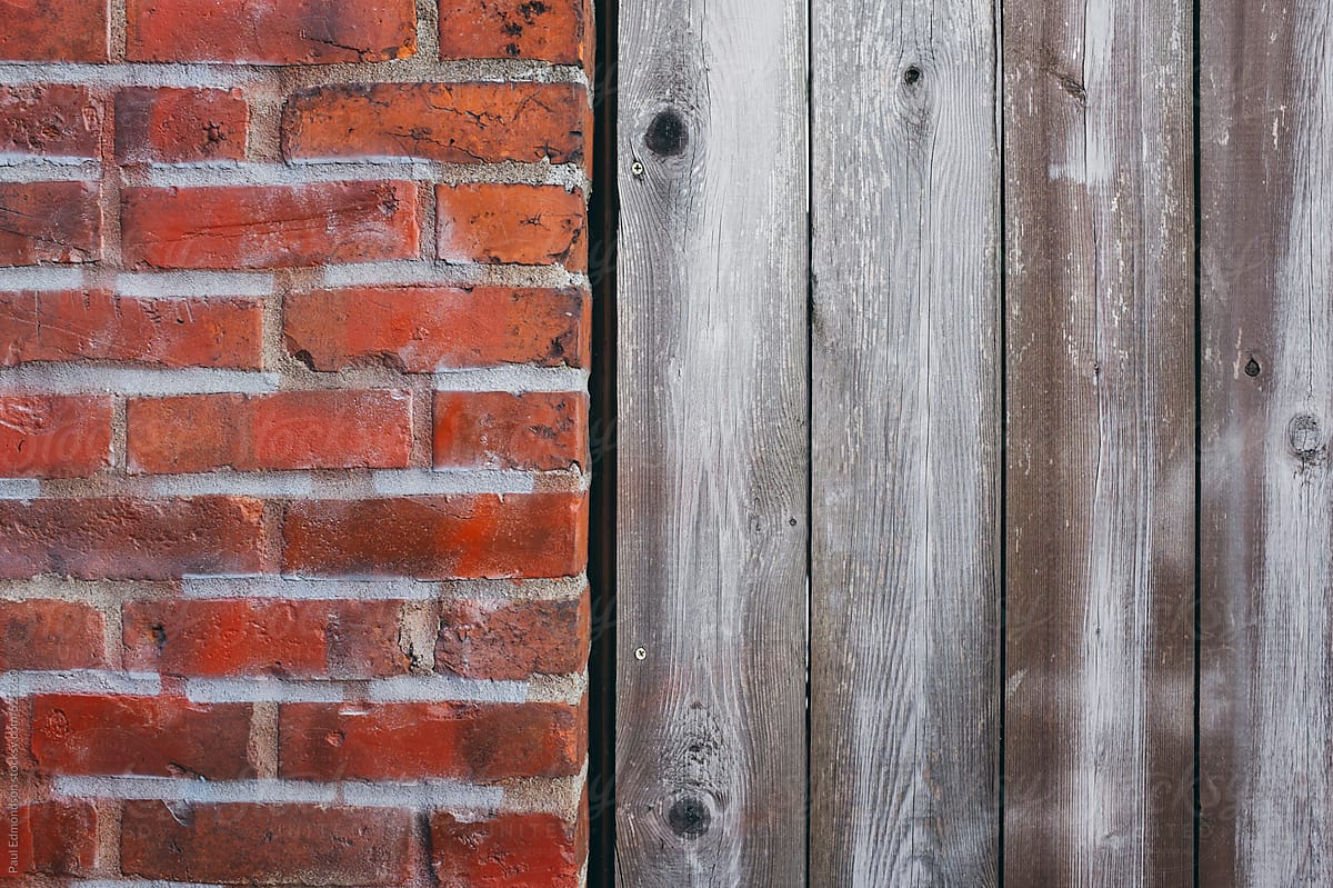 Detail of old brick wall and wood siding