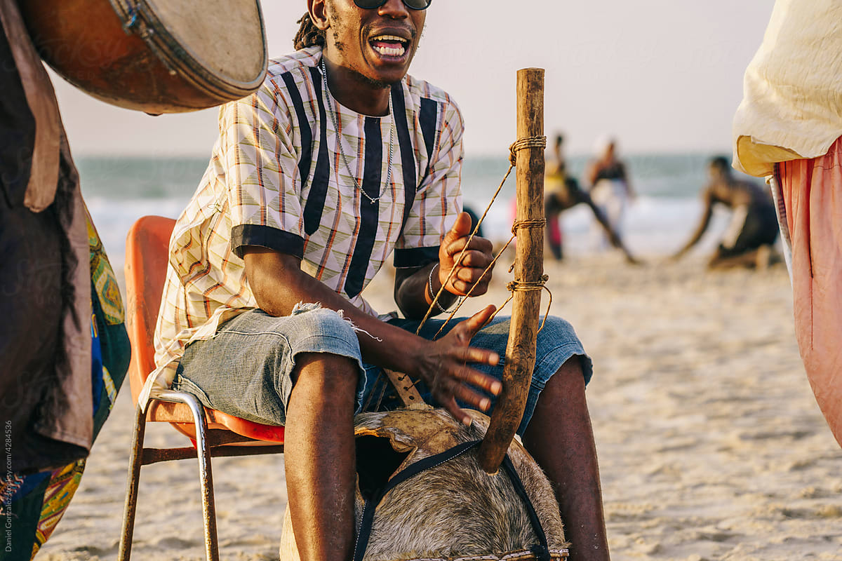 African musicians playing melody on shore