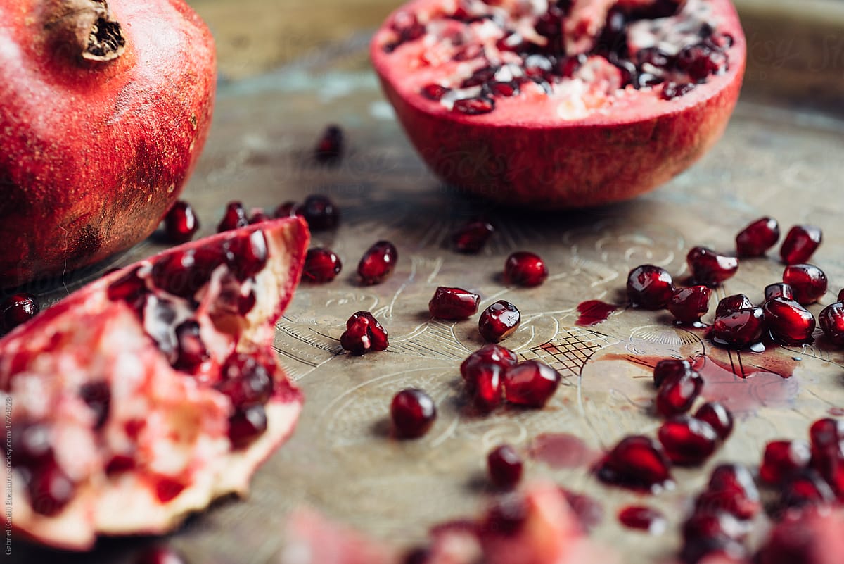 Close up of juicy pomegranate seeds on a brass tray