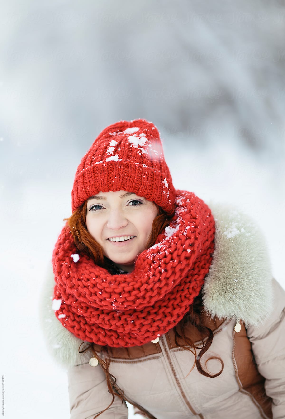 happy young woman plays with snow