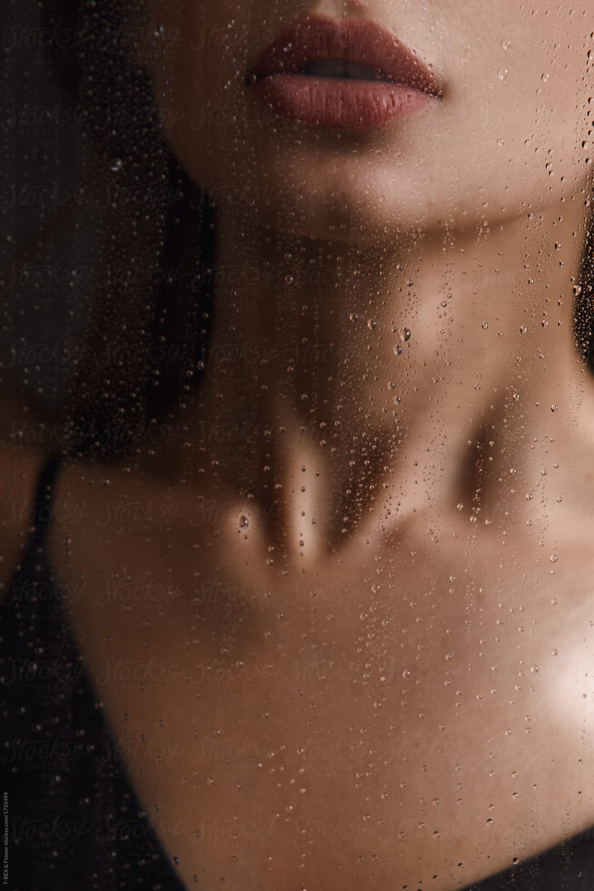 Sensual woman through wet glass