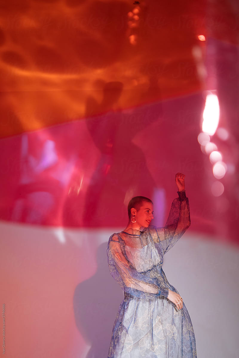 non-binary model in dress dancing in the studio