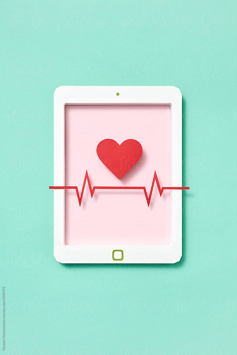 Graphic ekg line and heart symbol on a tablet screen.