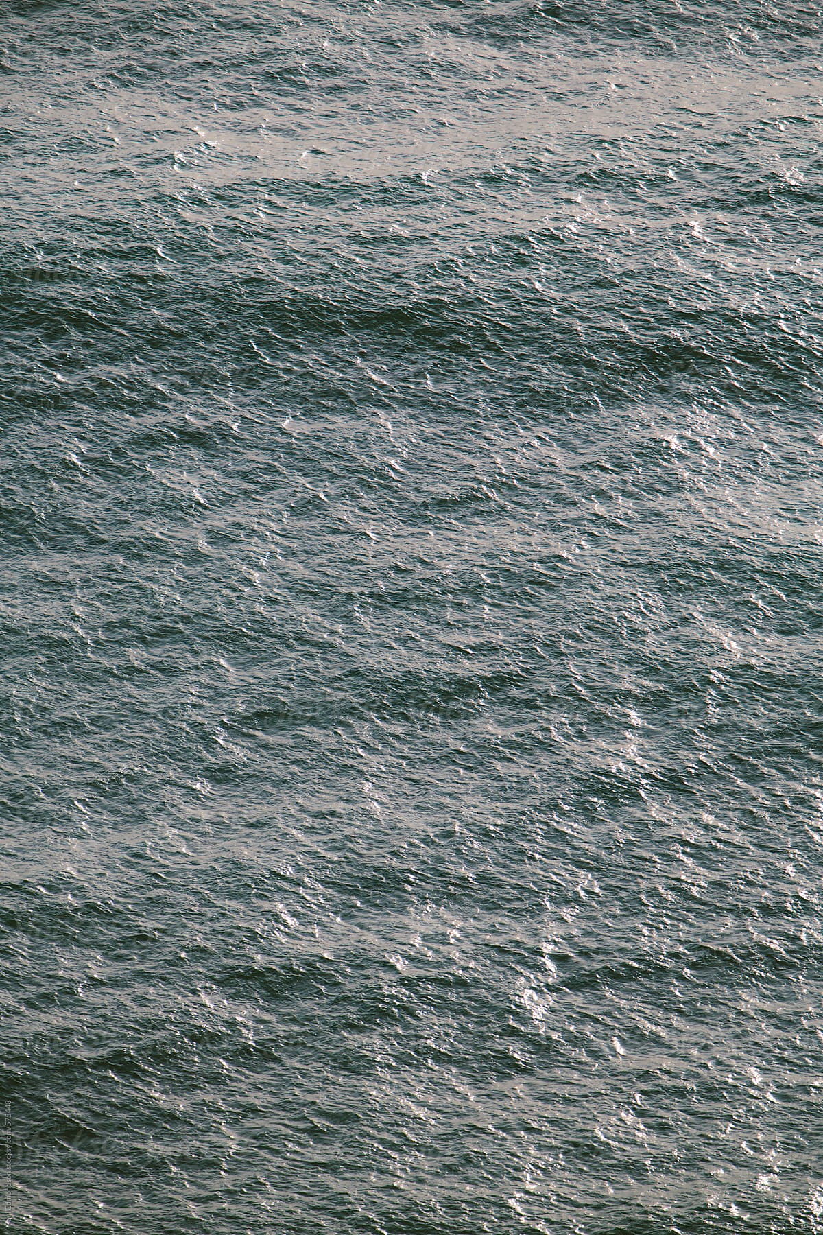 Detail of sunlight reflecting on ocean water and waves