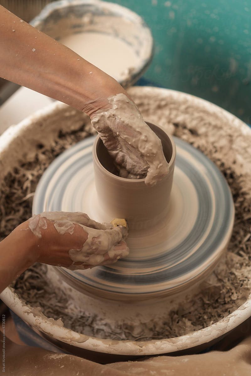 Close Up Of Anonymous Woman Shaping Clay On The Pottery Wheel