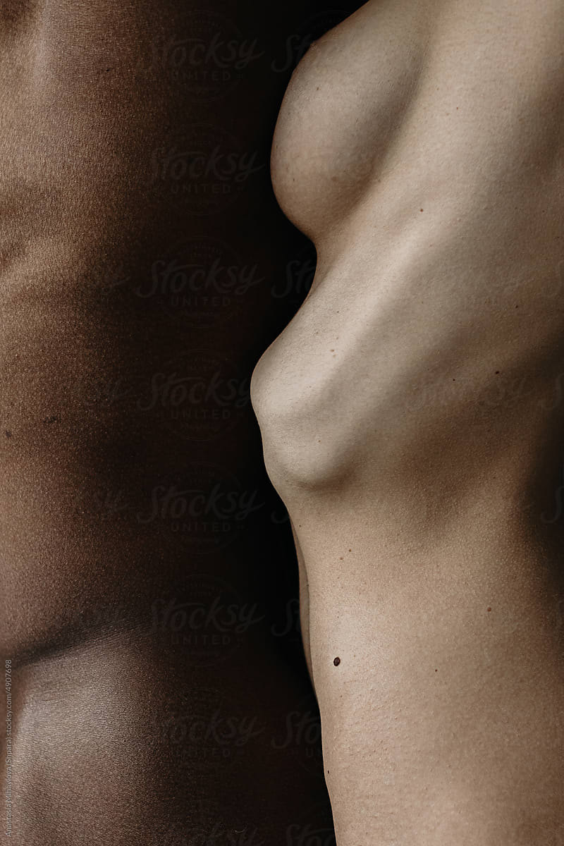 Close up skin texture of white woman and black man standing together