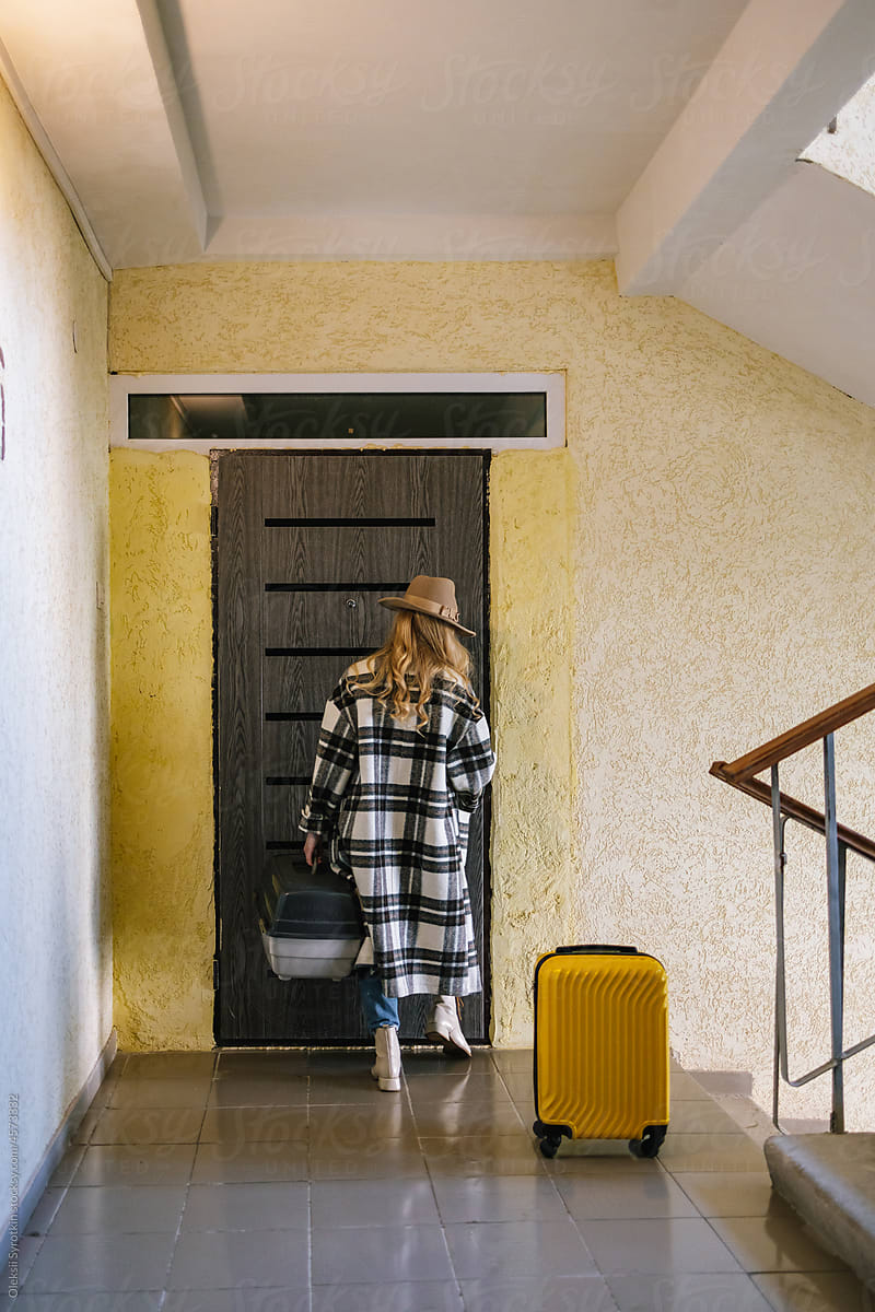 Female tourist closing door of apartment