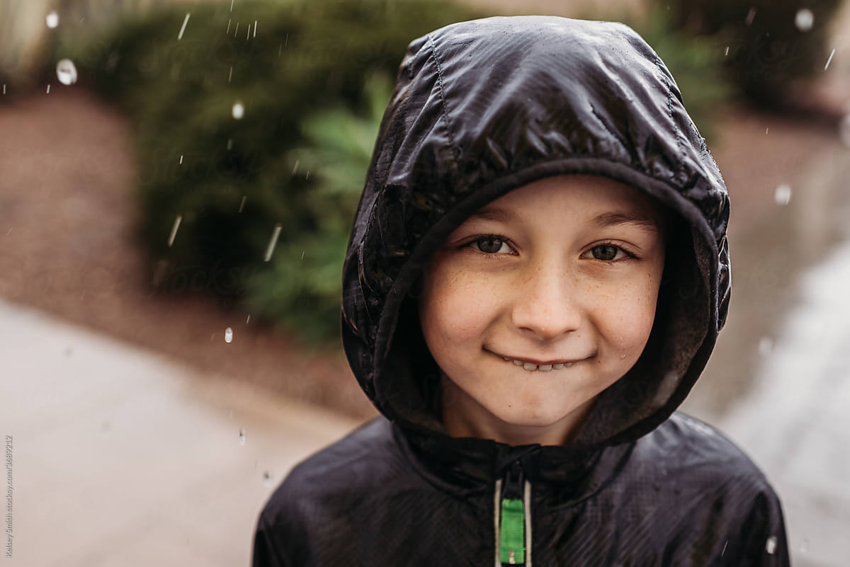 School age boy in rain storm