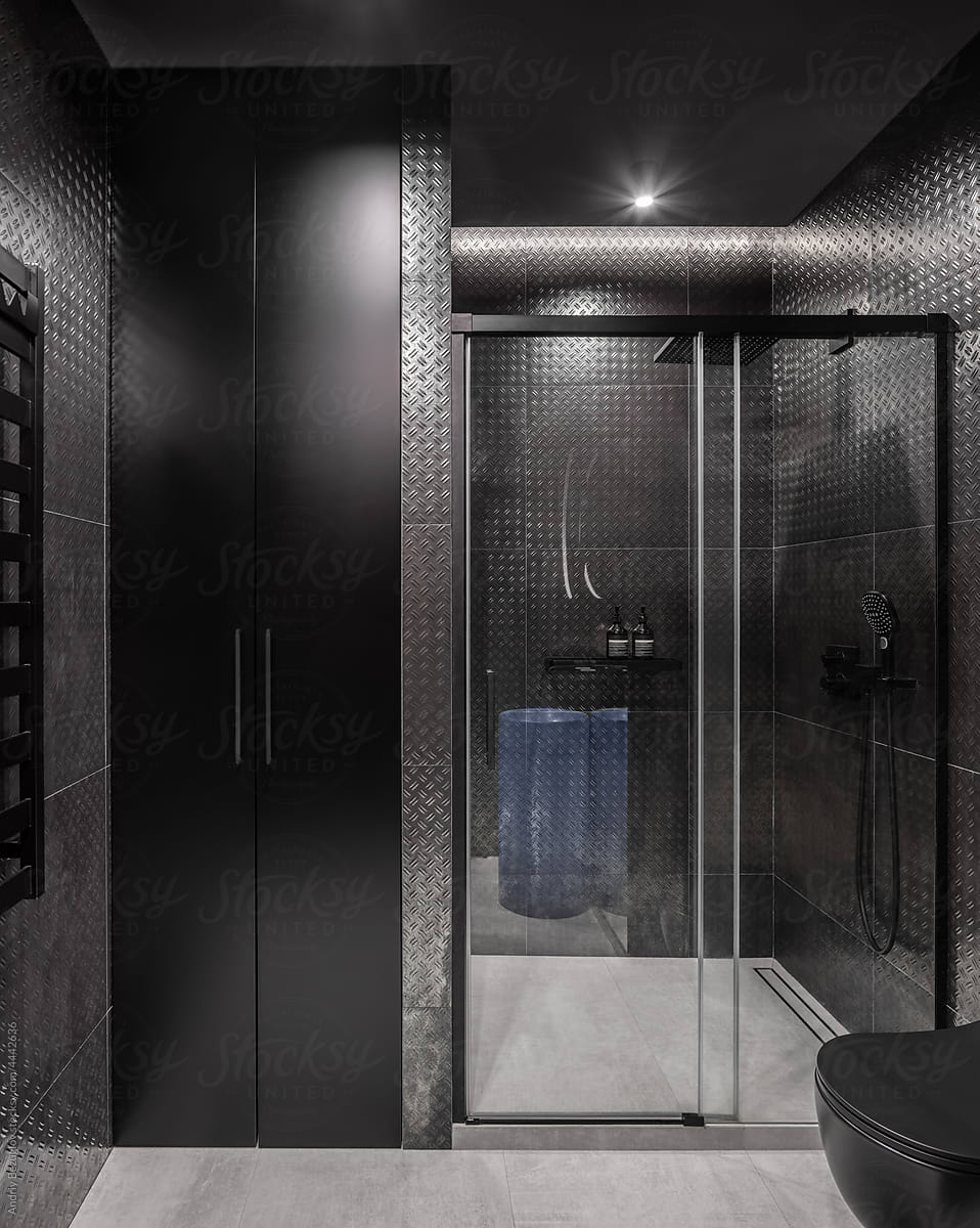 Illuminated bathroom in contemporary style with dark walls