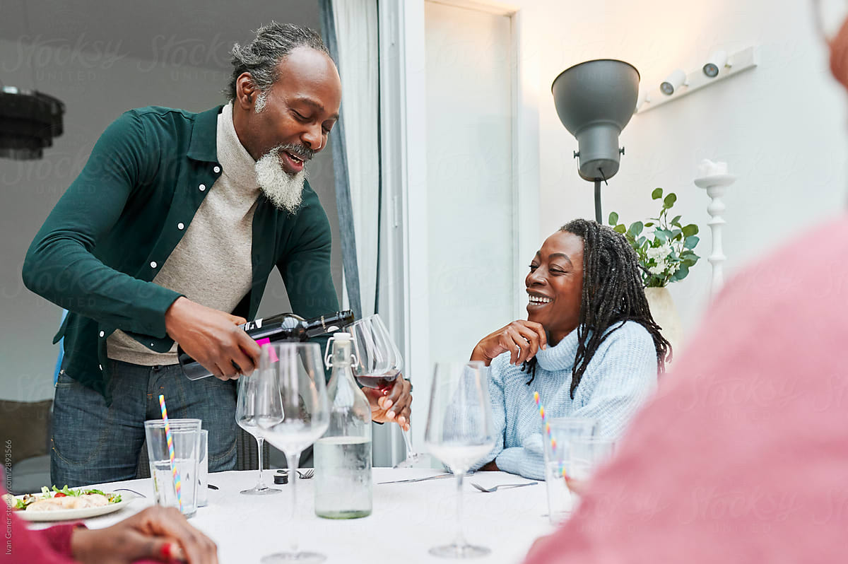 Smiling family having wine with dinner