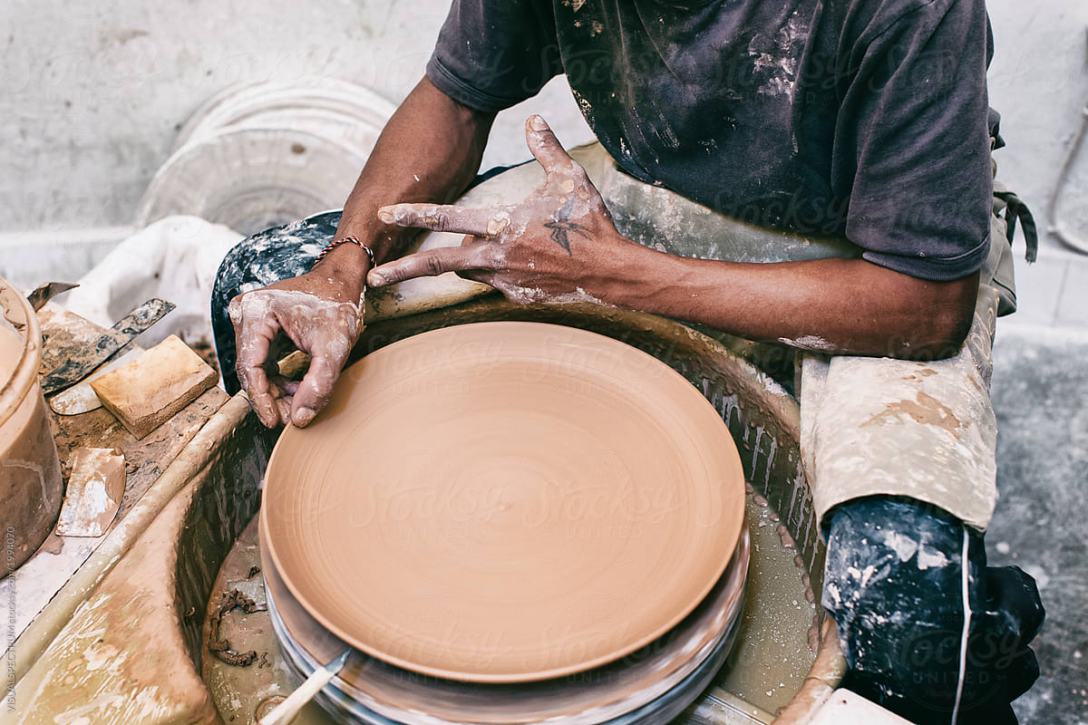 Closeup on Hands of Artisan Potter Making Large Plate