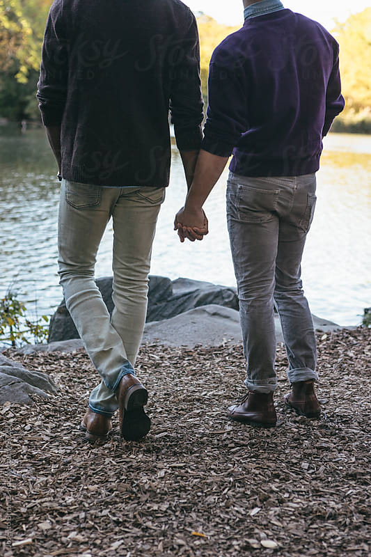 Young Gay Men Couple Holding Hands Together Enjoying Romantic Central Park In Autumn In New York