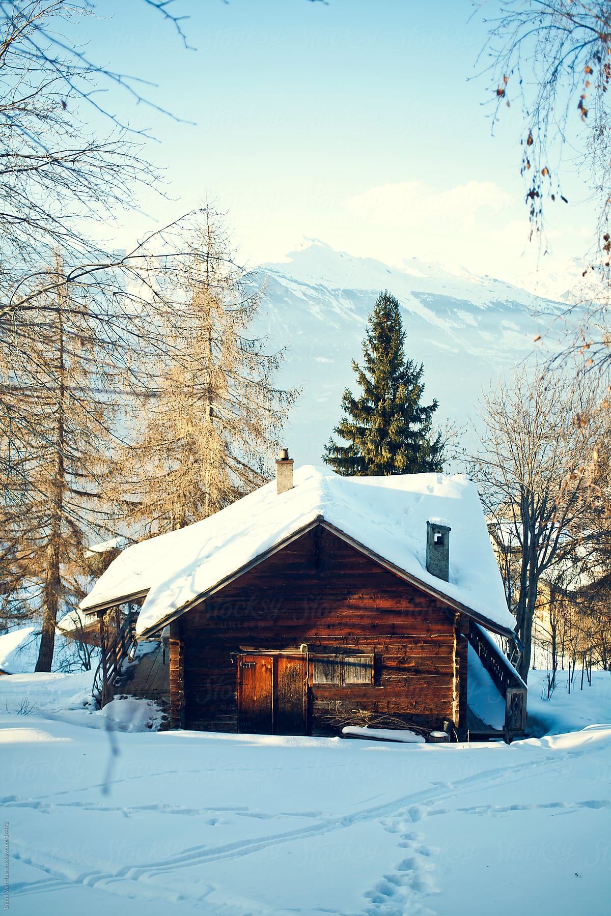 Wooden cabin in the snow in the mountains