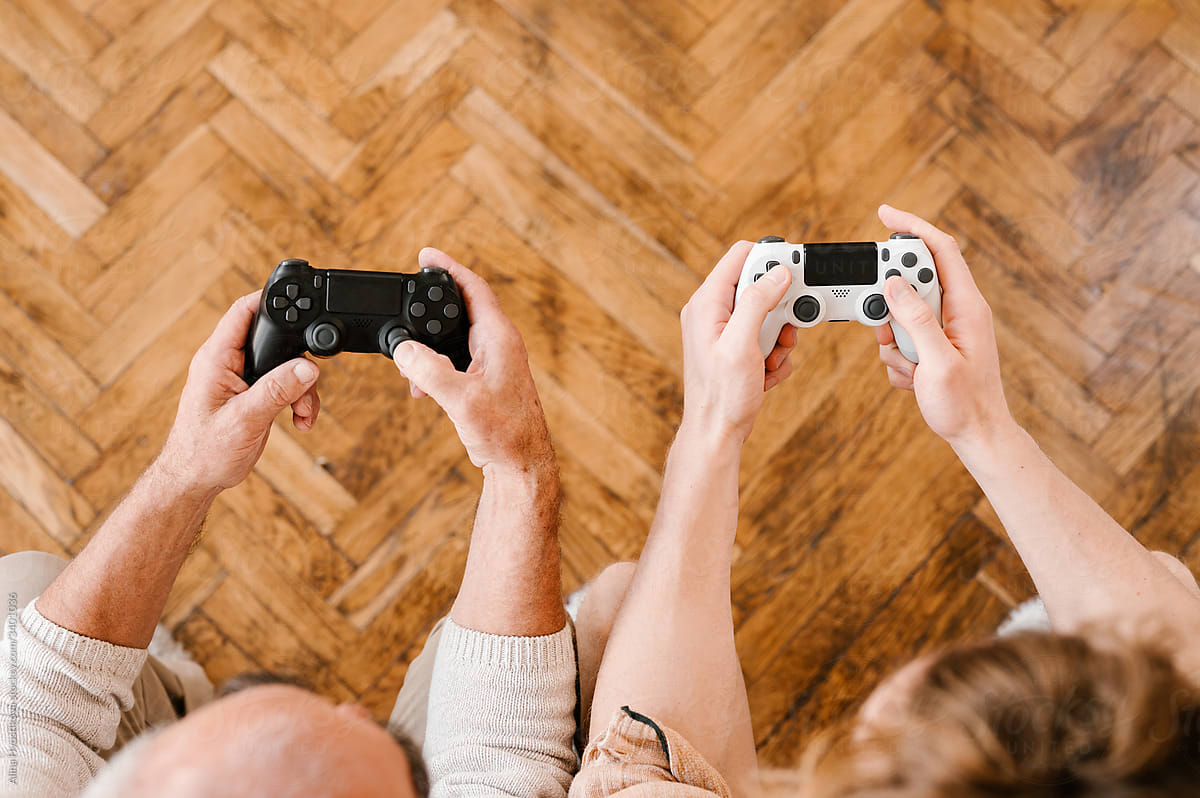 Father and son with gamepads playing video game