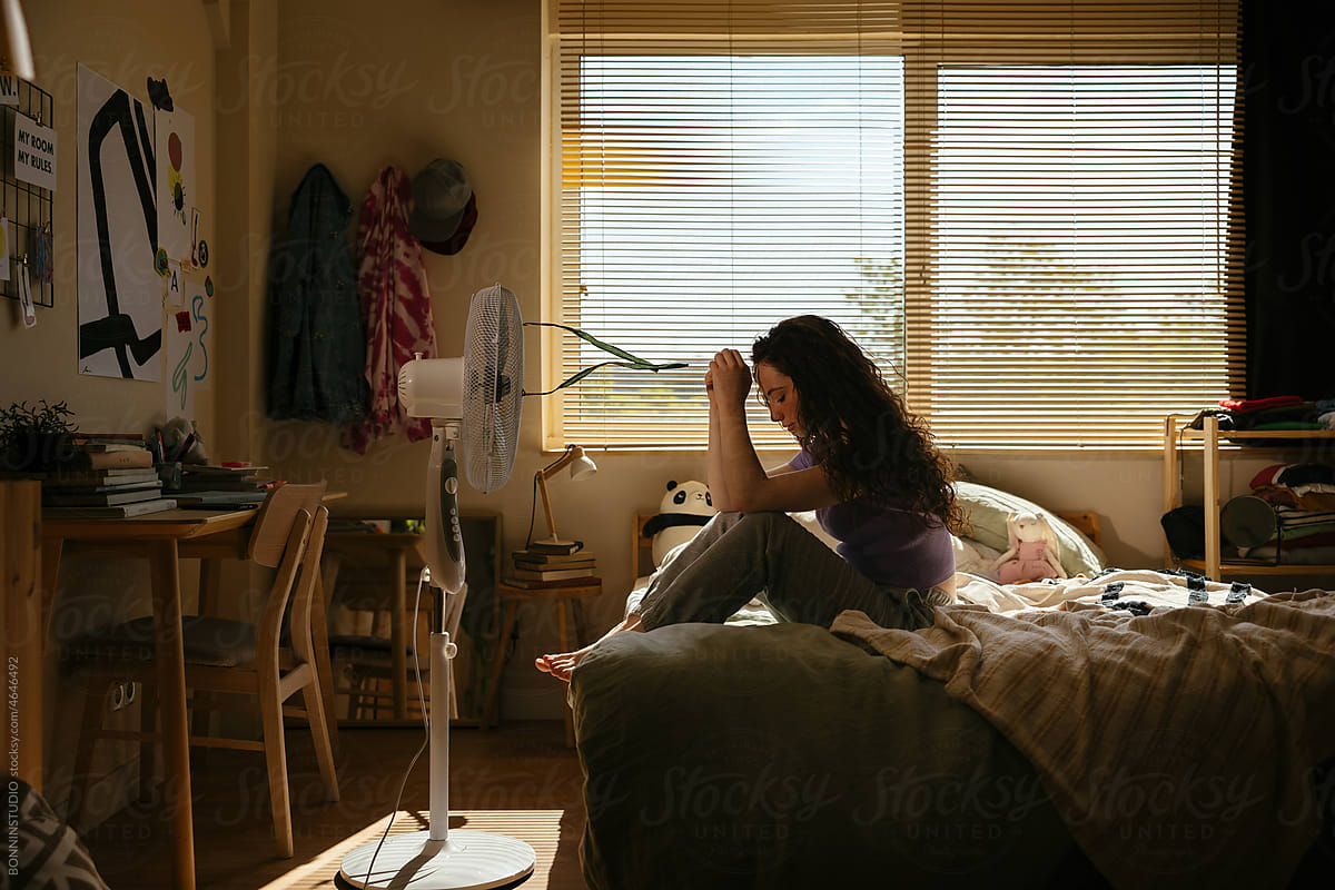 Teen resting on bed in own room