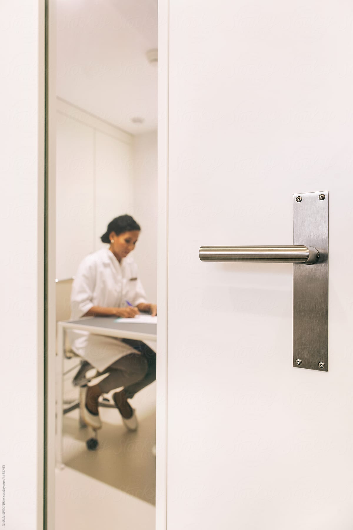 Female Doctor Working Behind Closed Door