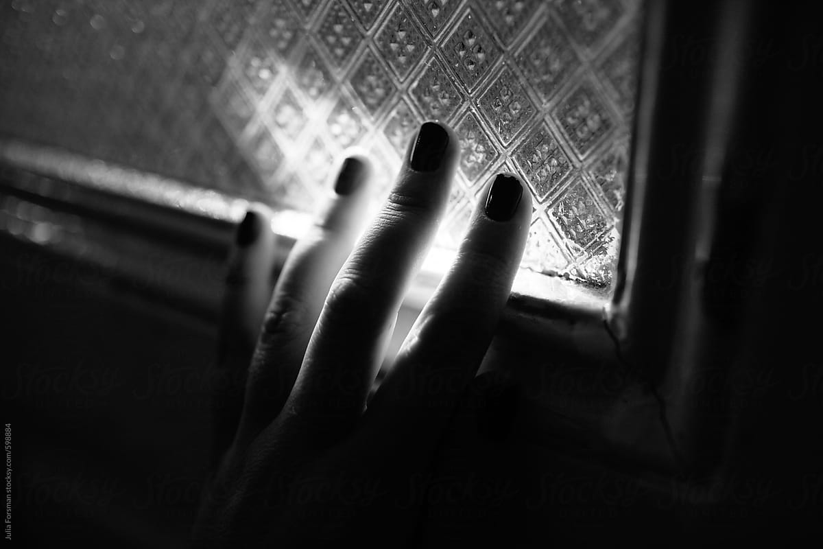 Detail of woman\'s hand touching glass