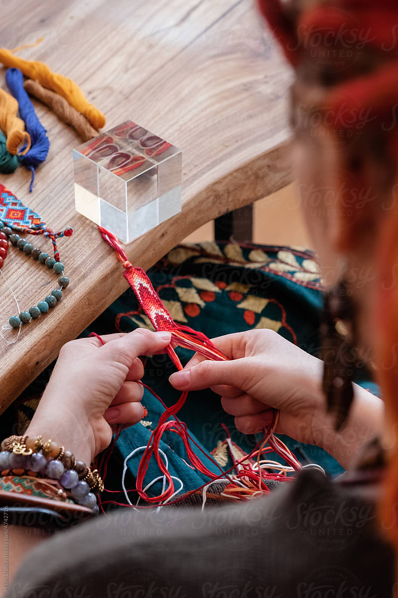 Anonymous female artisan creating friendship bracelet