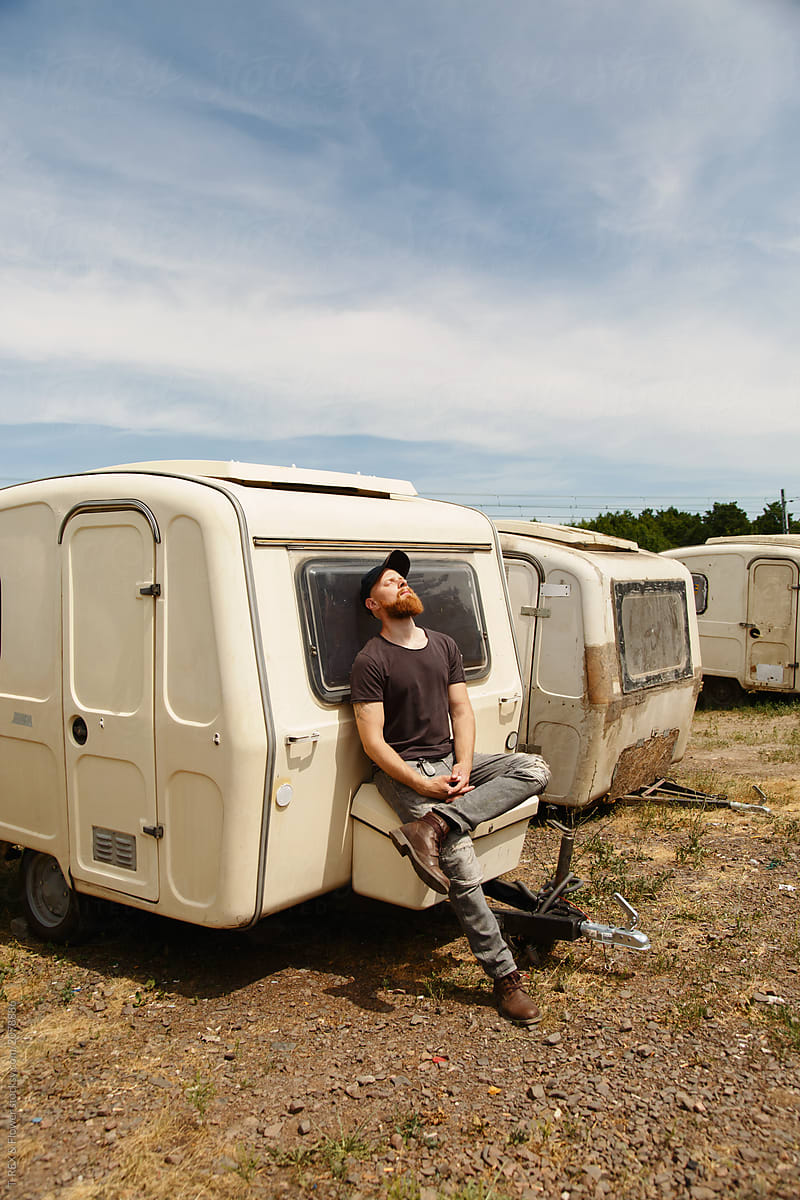Man relaxing and leaning on trailer