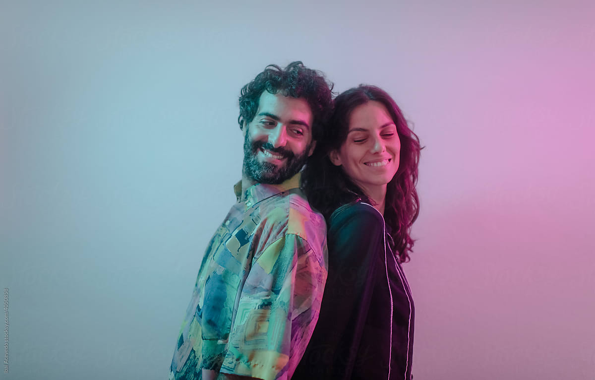 Smiling couple under neon lights