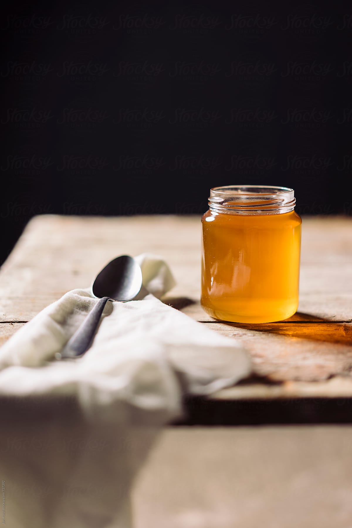 a glass honey jar on a table