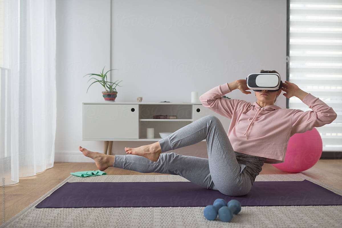 Woman doing pilates at home with vr gear