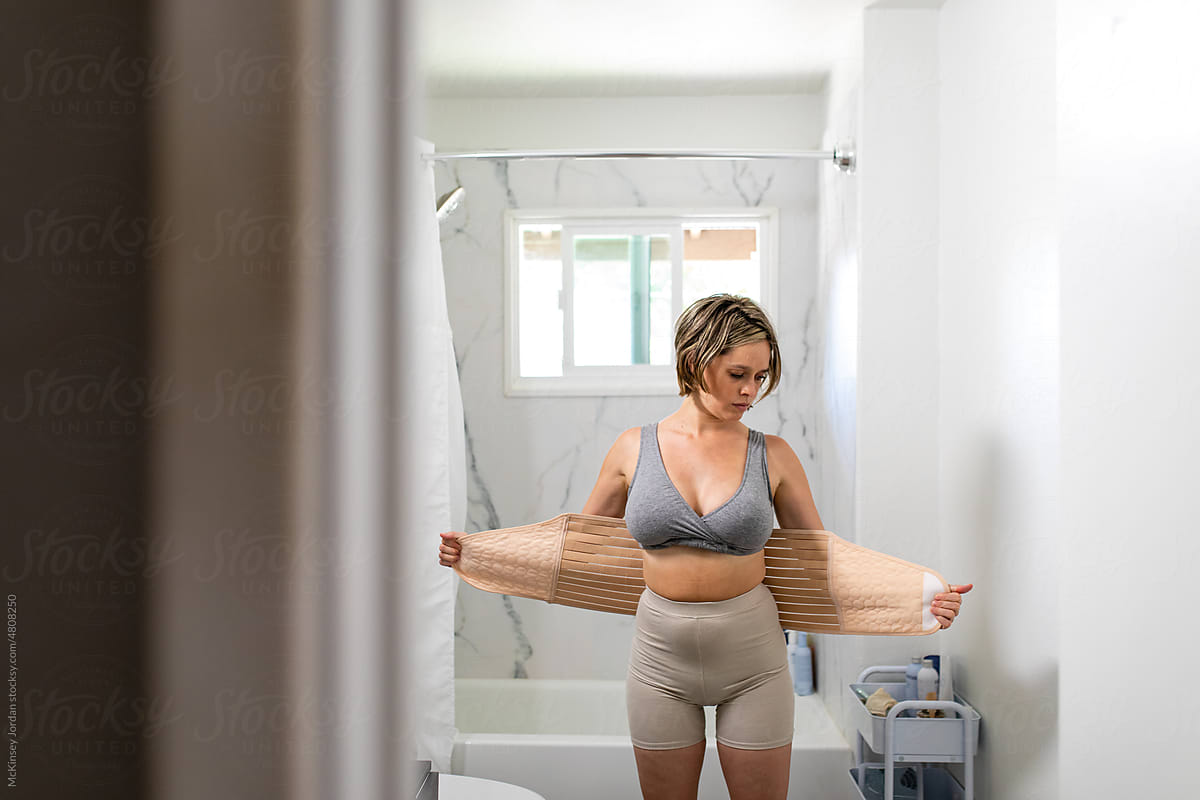 Mother Wraps Her Stomach With A Belly Band Post Pregnancy