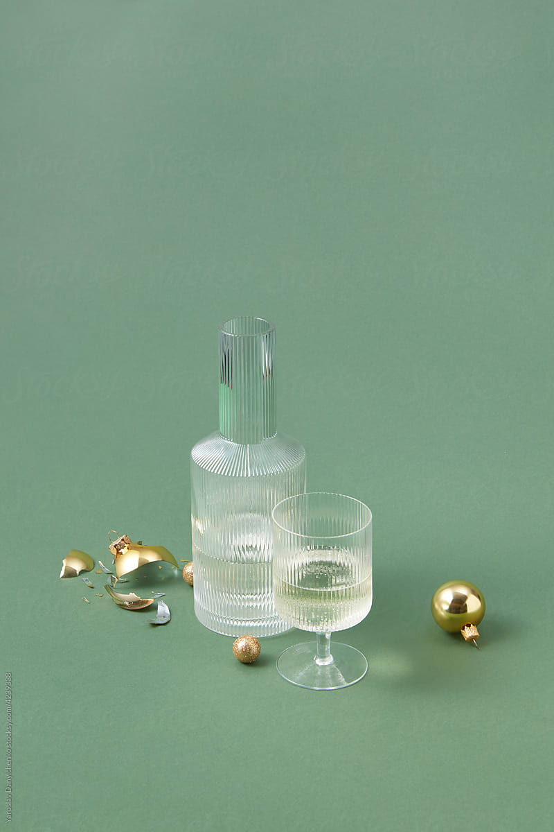 Decanter and glass of champagne among baubles