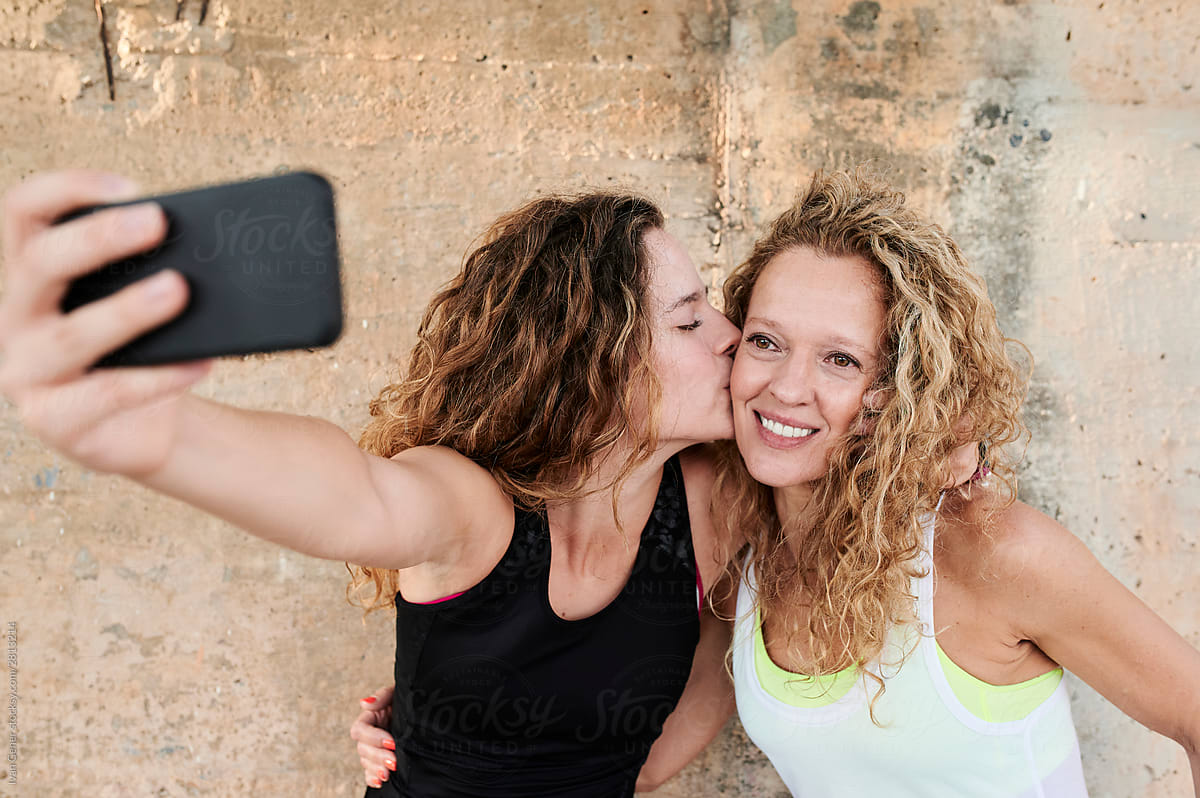 Sporty mom and daughter taking a selfie