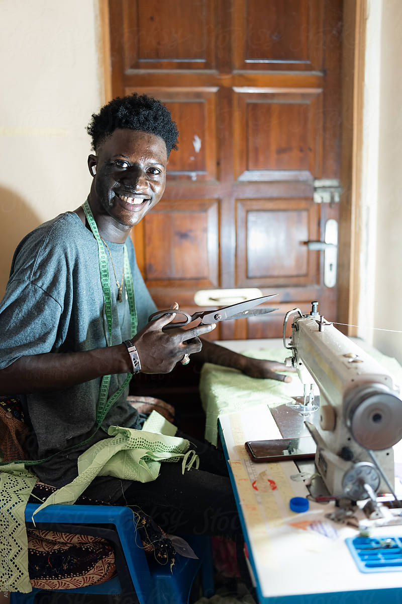 Male Dressmaker Using Sewing Machine by Stocksy Contributor Alvaro Lavin  - Stocksy
