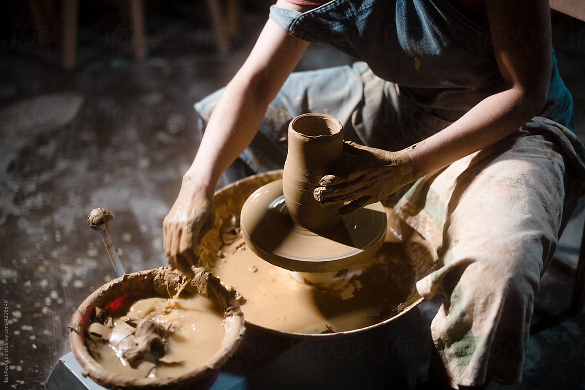 Pottery artist moistening hands