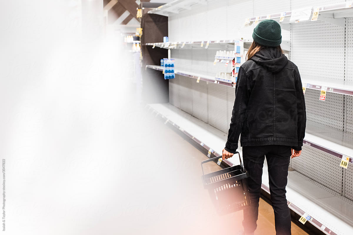 Person waking through an empty grocery store during the Coronavirus pandemic