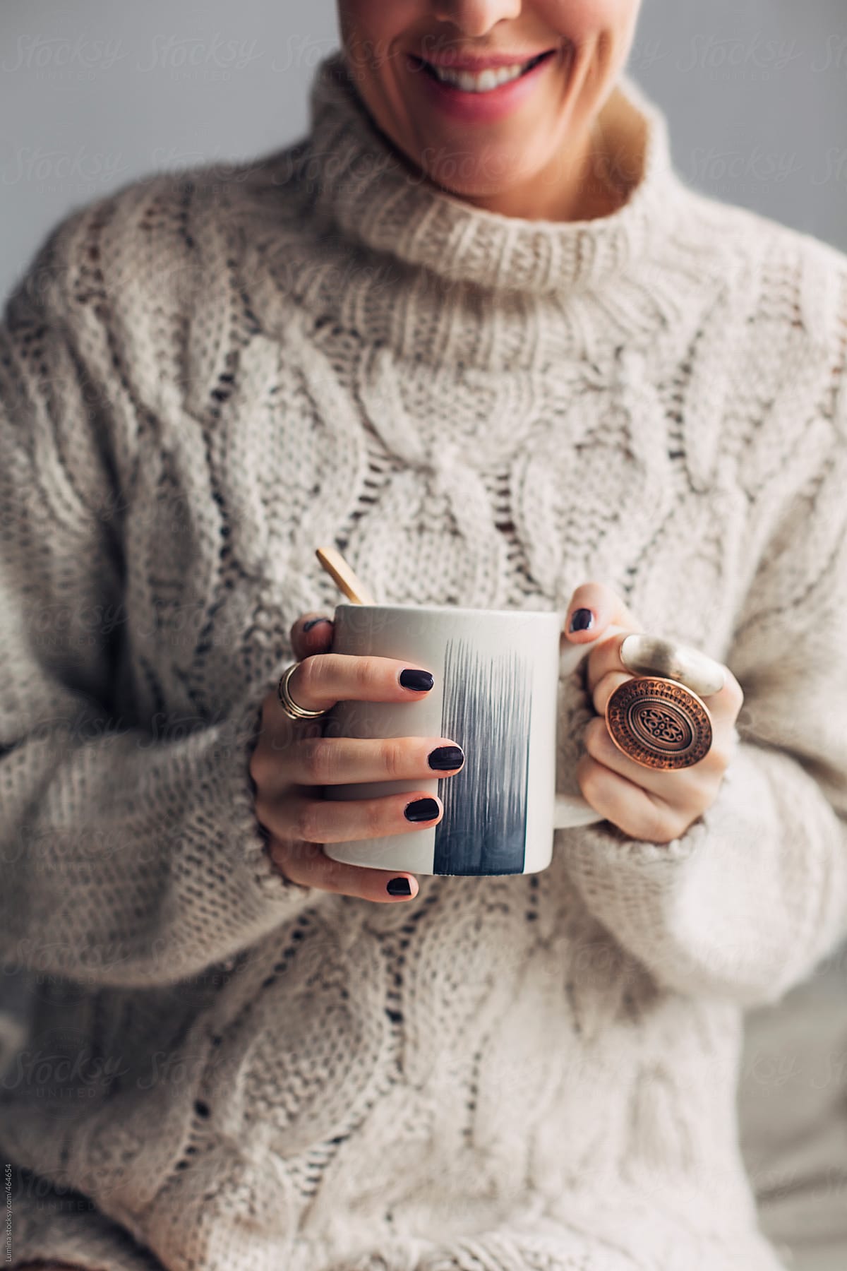 Woman in a Sweater Holding Hot Coffee