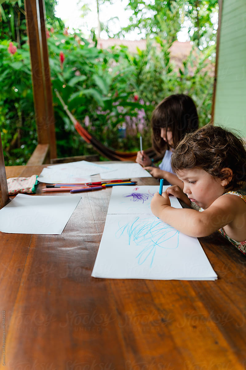 Little girls drawing outdoors