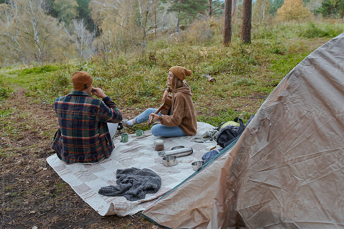 man and woman in tent on hike in nature forest park