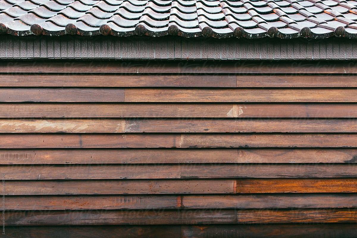 An upclose shot of wooden house with tiled roof