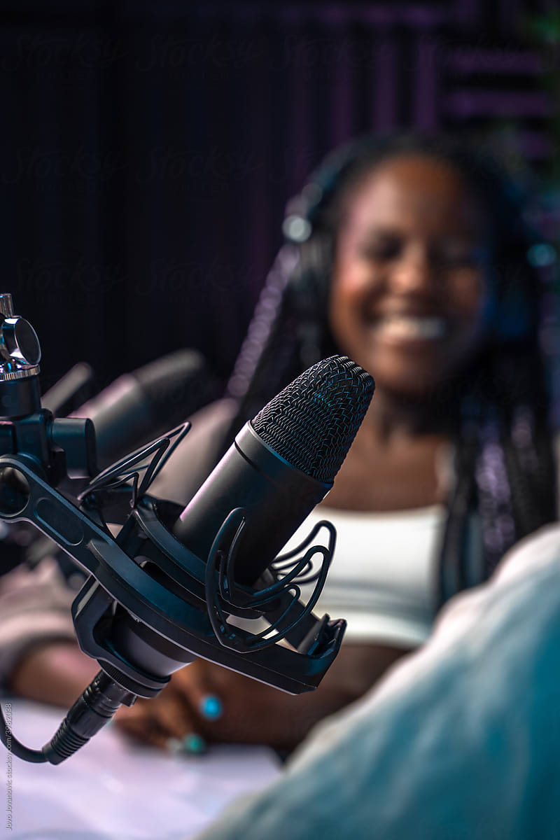 Studio microphone with woman in background