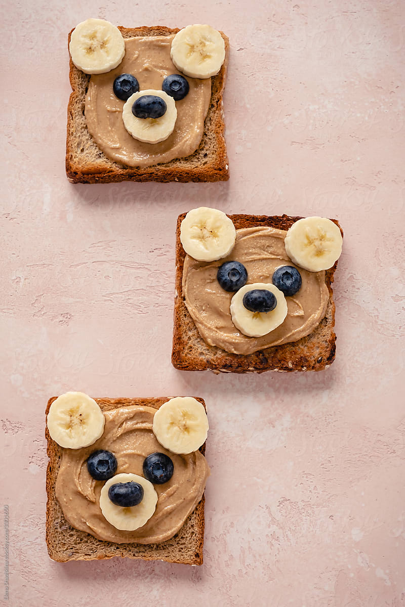 Cute bear face toasts with peanut butter, banana and blueberries