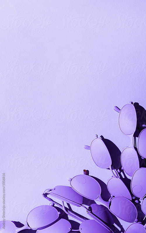 Purple/ violet sunglasses on purple/violet background.