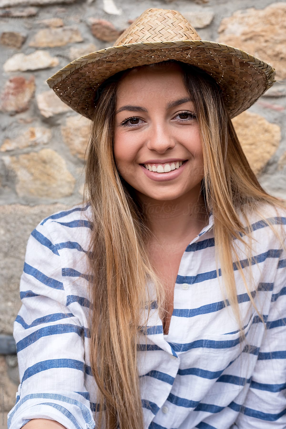 Young female in straw hat smiling