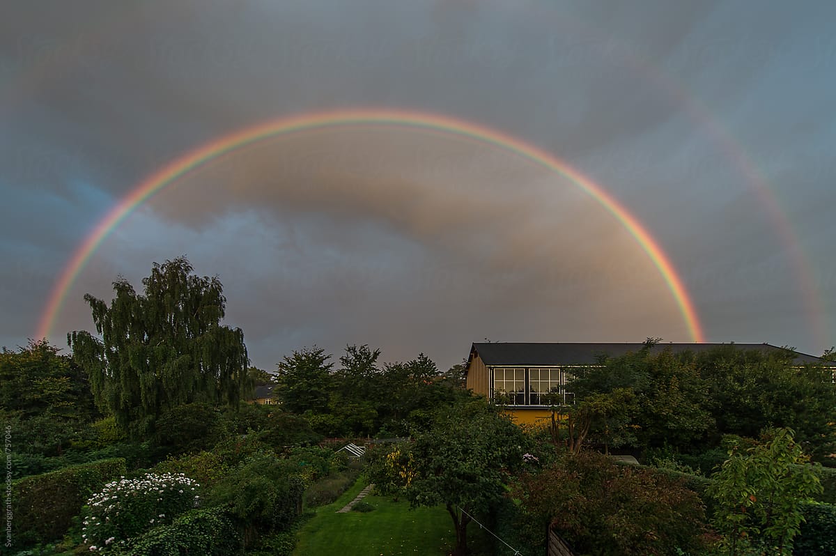 A double Rainbow above a green garden